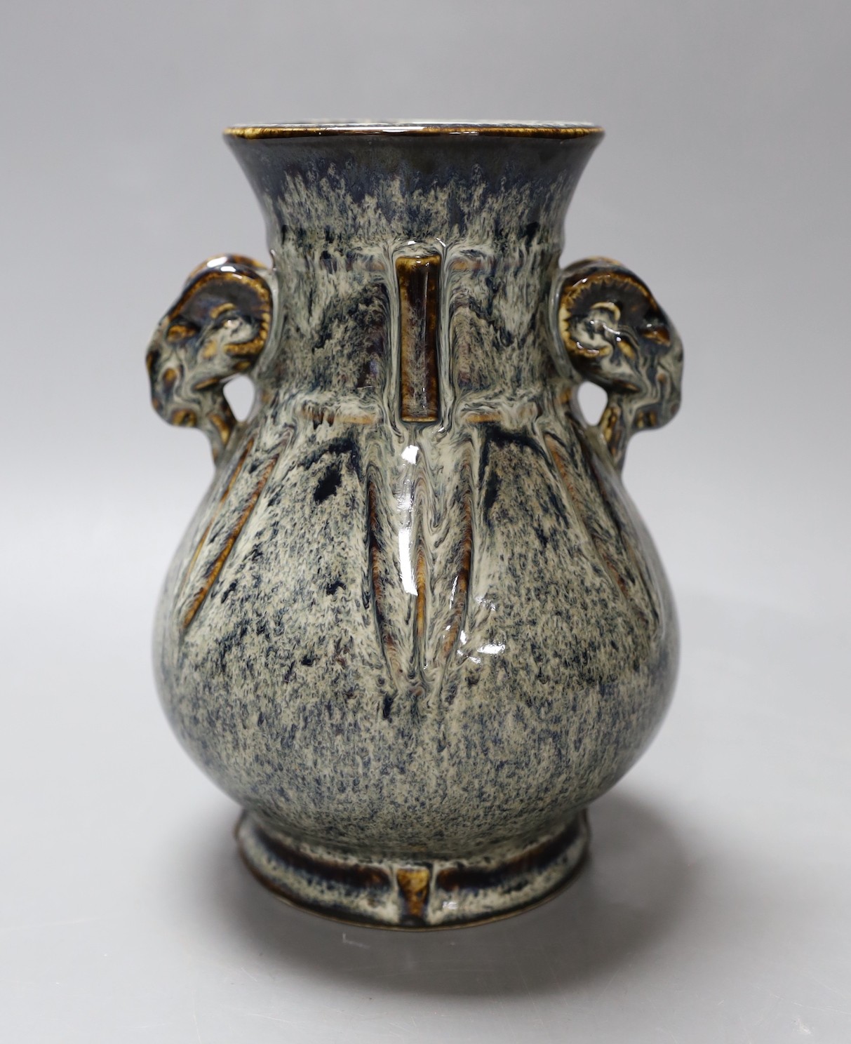 A Chinese Shiwan pottery ram's head handled hu vase. 17cm high